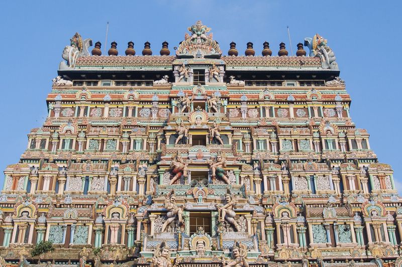 A tall gopuram of the Nataraja temple at Chidambaram, densely covered with painted sculptures