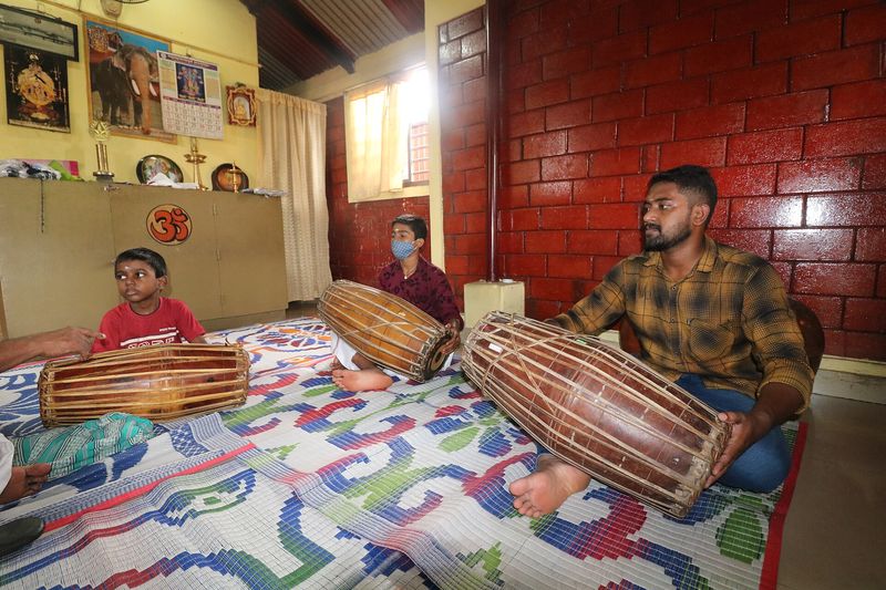 Students learning to play the mridangam at a percussion school.