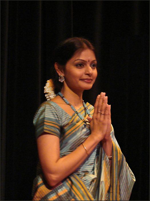 Vocalist Ramya Sundaresan standing with palms joined in a namaskaram at the end of a Bharatanatyam recital in Paris.